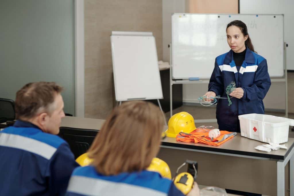 Workplace safety training with instructor and employees in a classroom setting.