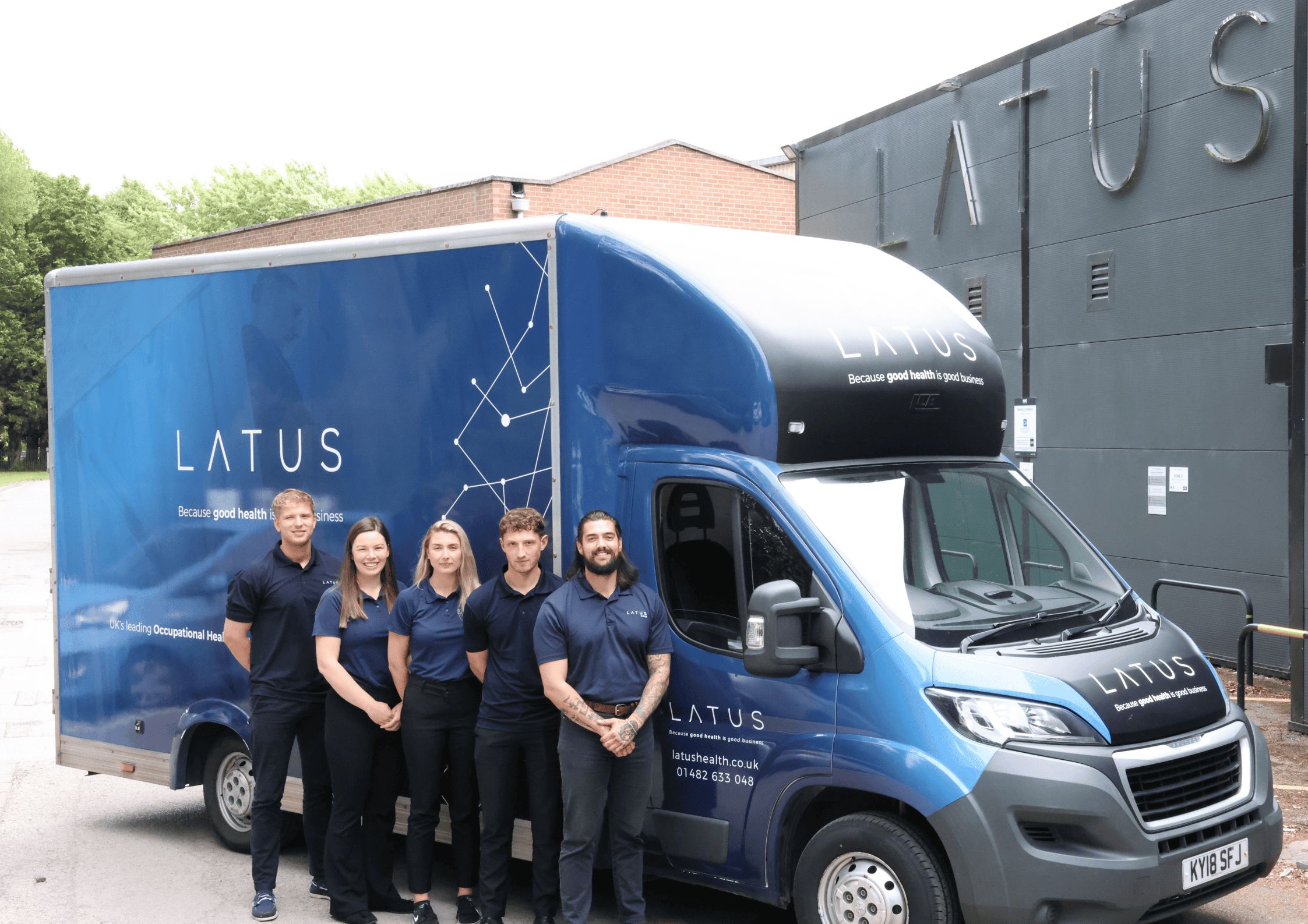 LATUS Group medical transport team with delivery van outside hospital.