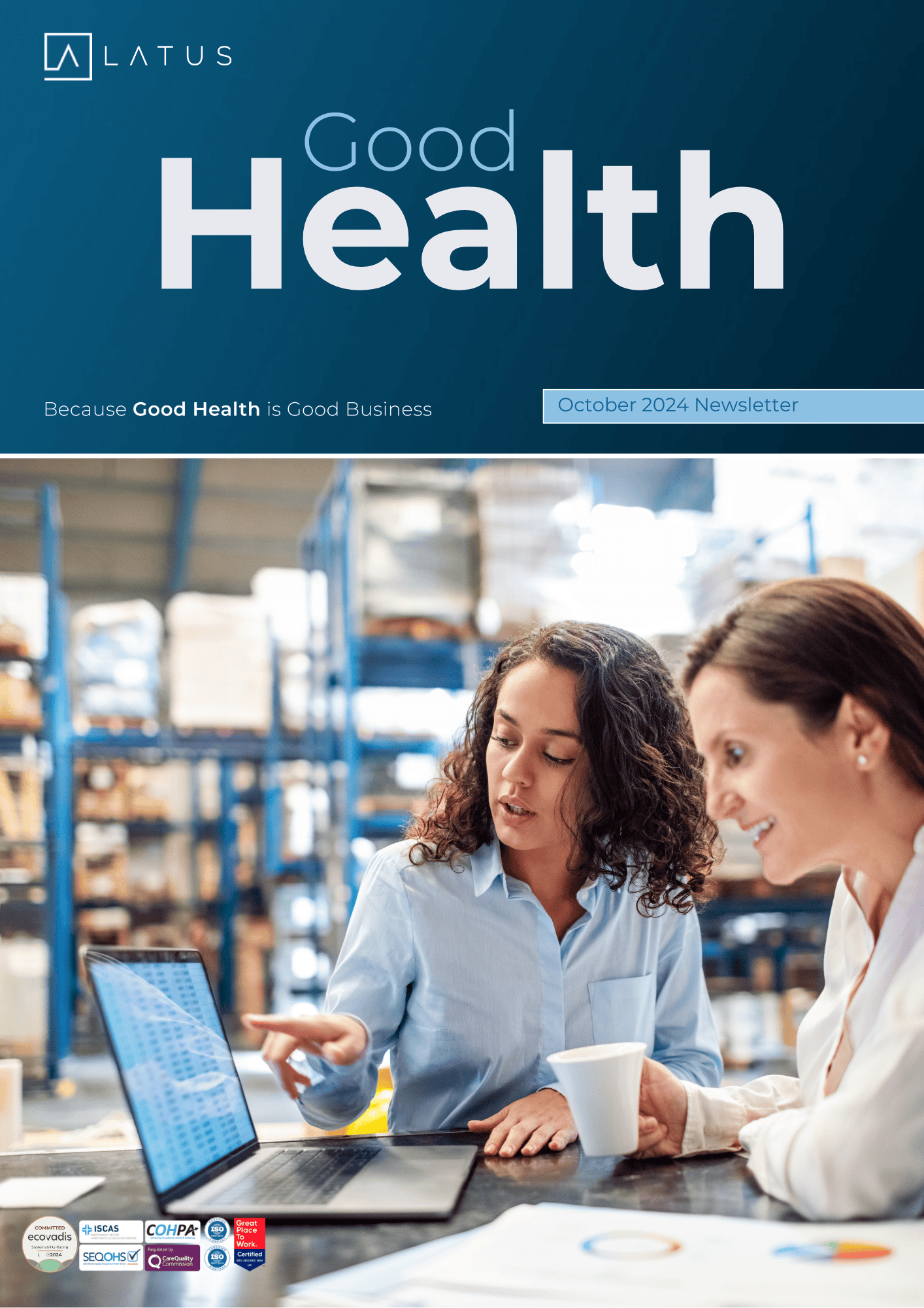 Two women discussing health data on a laptop in a warehouse setting.