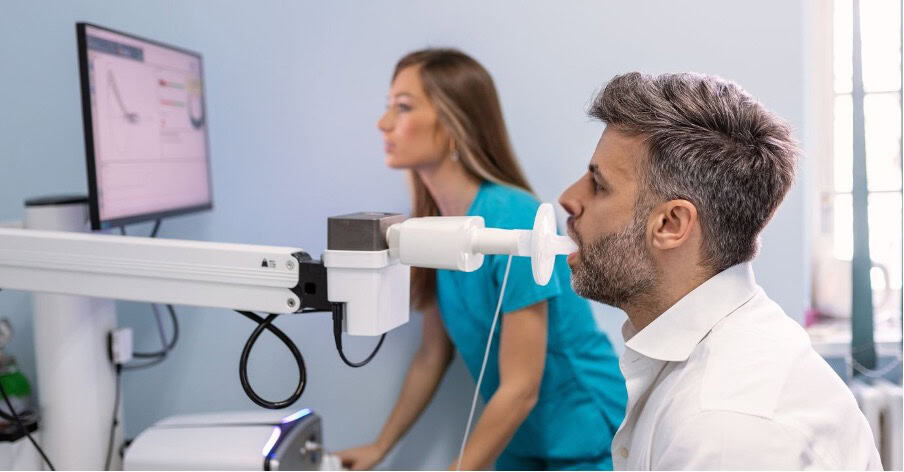 Man undergoing lung function test for occupational asthma assessment.