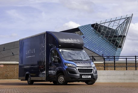 LATUS Group delivery van parked outside modern building in London.