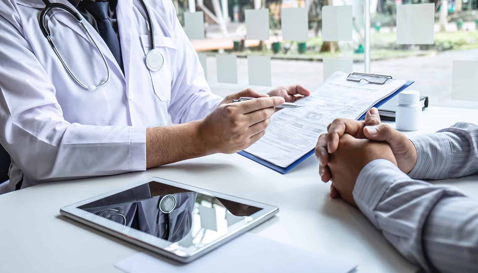 Healthcare professional discussing vaccination plans with employee at workplace.
