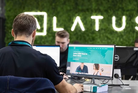 LATUS Group team working at computers in office environment.