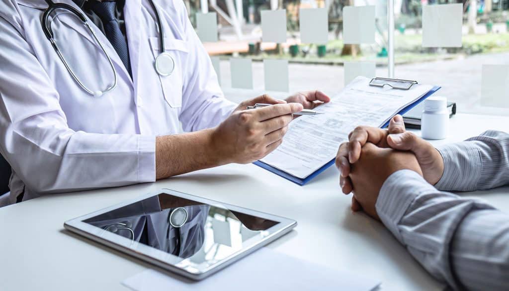 Medical professional conducting pre-employment health screening interview.
