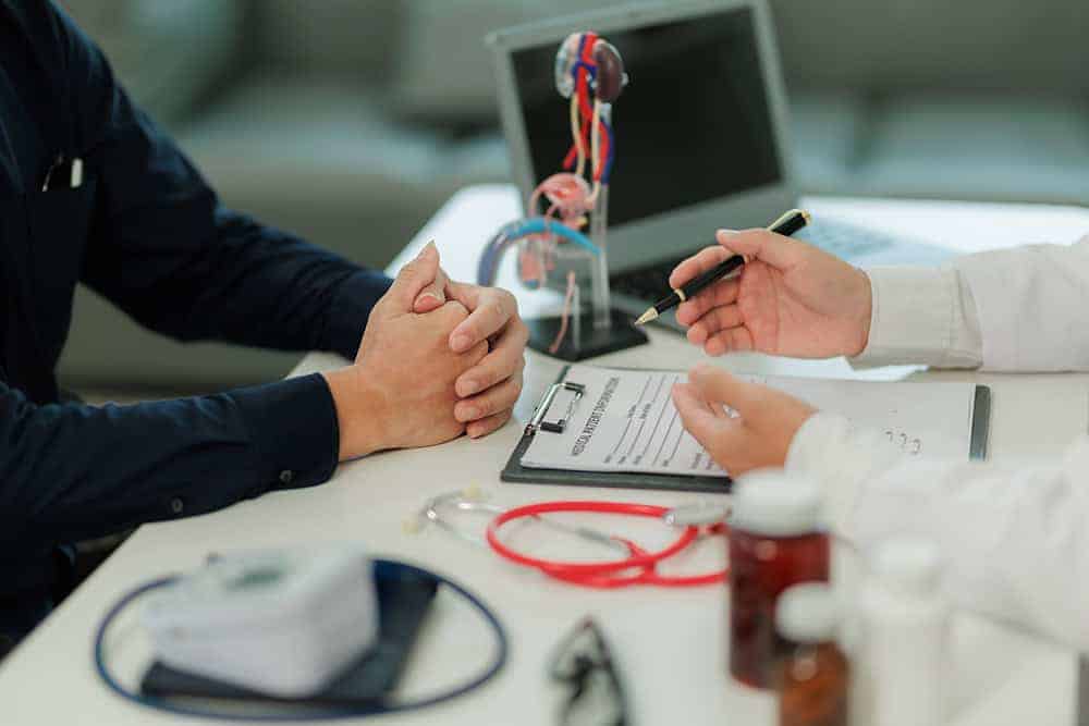 Medical professional discussing health surveillance with patient in clinic.