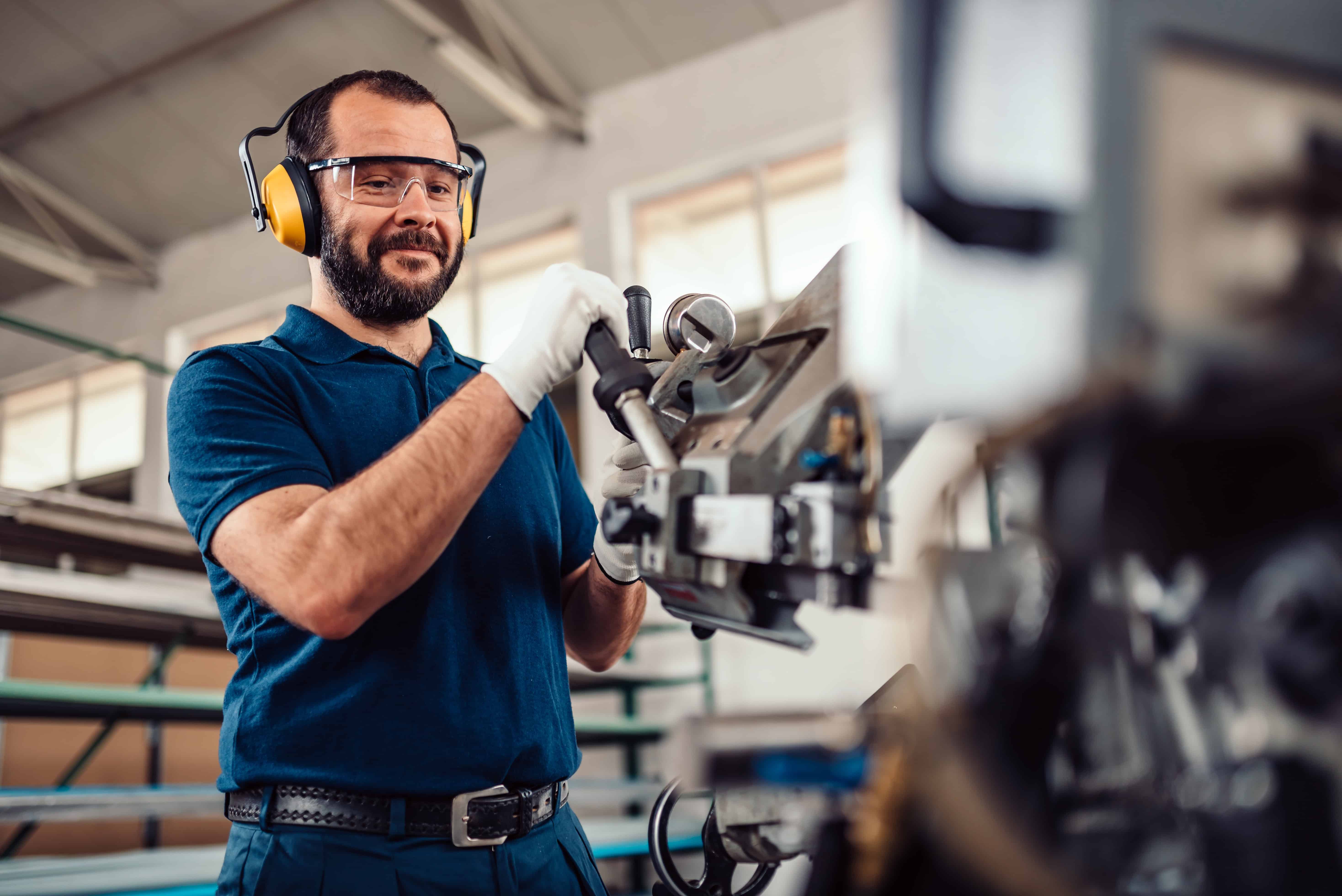 Precision engineering technician working with advanced machinery at LATUS Group.