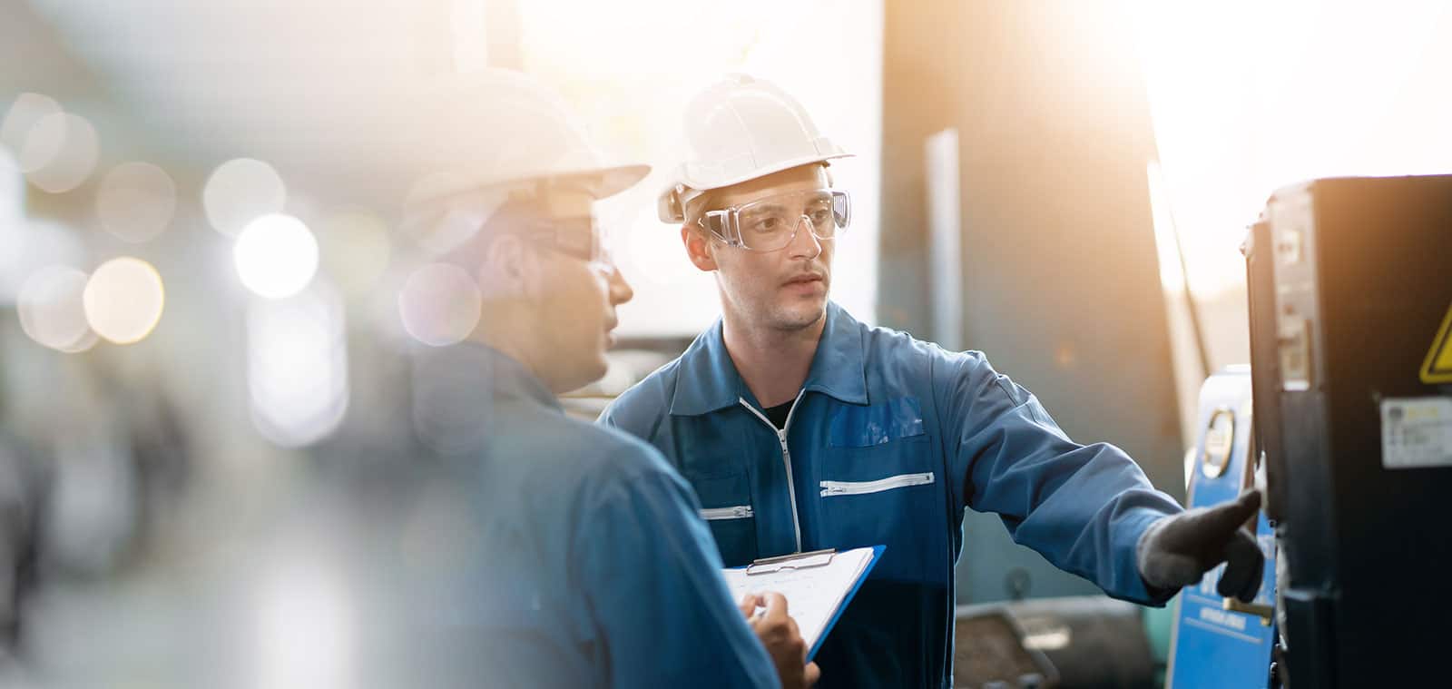 Engineers conducting noise survey assessment in industrial setting for compliance and safety.