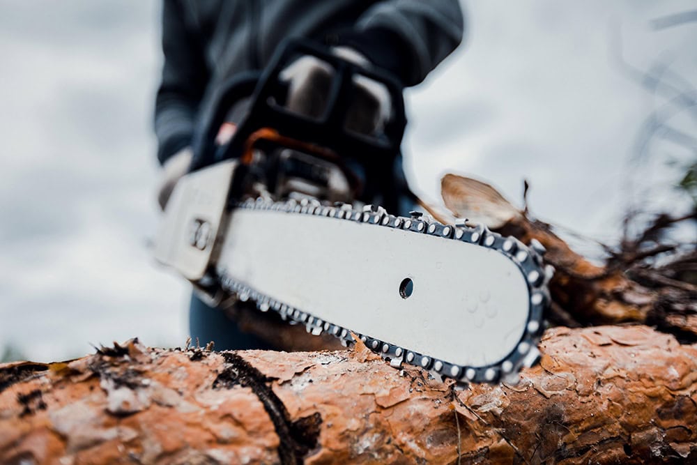 Chainsaw safety gear for HAVS risk reduction in industrial environments.