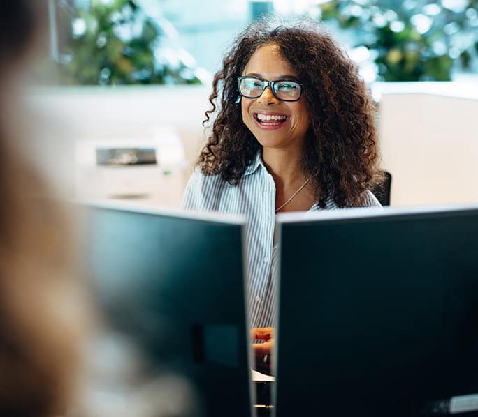 Woman smiling during a mental health discussion at work.