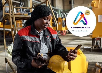 Woman in industrial setting checking phone with Neurodiverse Workplace logo.