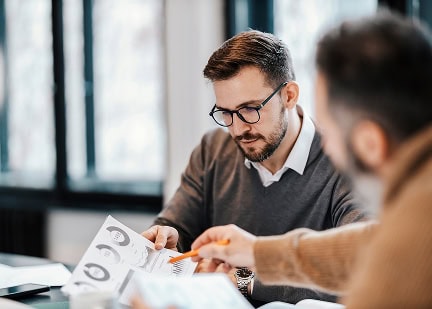 Business professional discussing neurodiversity certification with colleague.