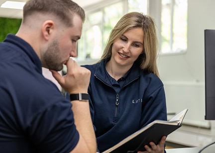 Professionals discussing neurodiversity certification in a workplace setting.