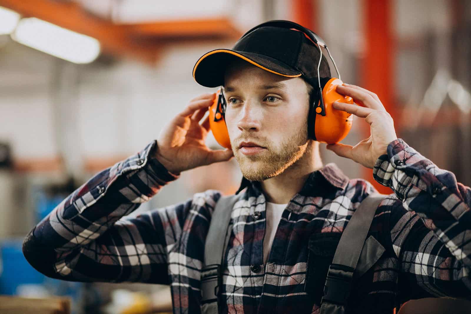 Man wearing hearing protection during audiometry testing at LATUS Group.