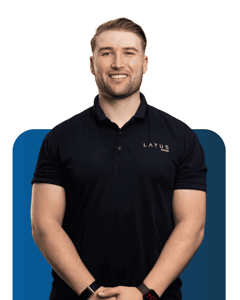 Professional team member wearing LATUS Group uniform smiling confidently.