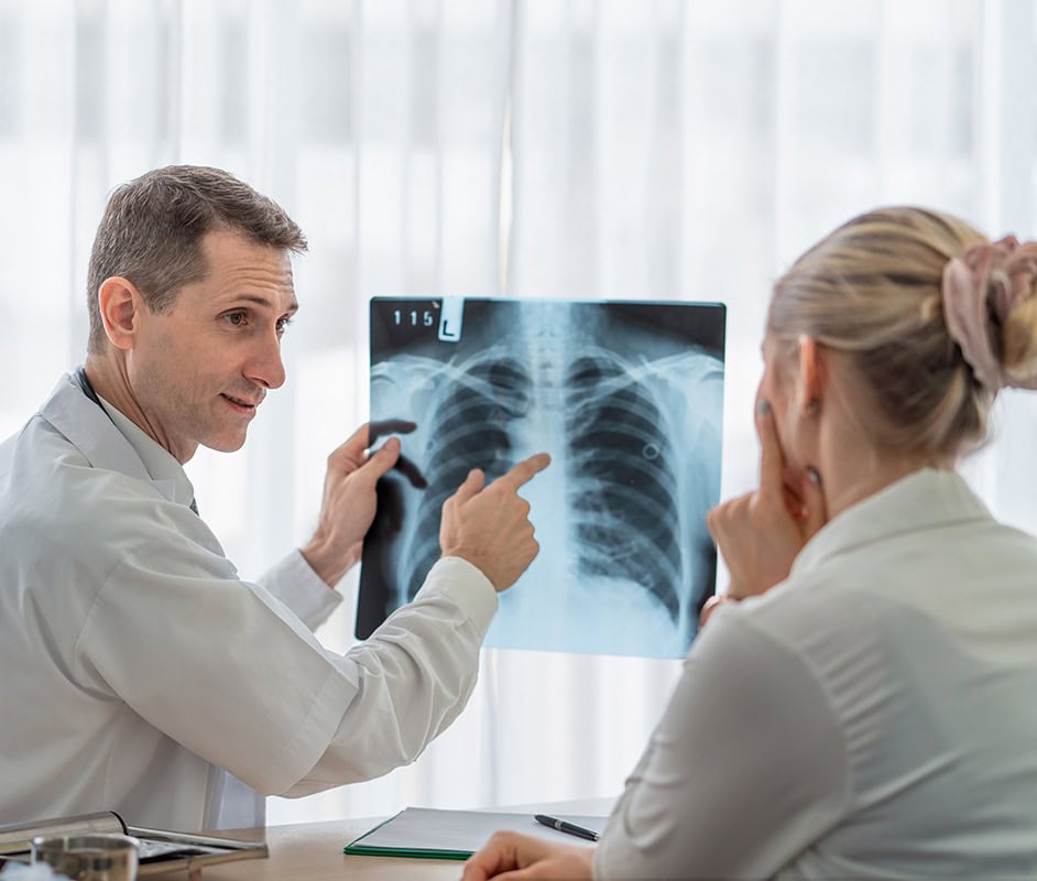 Medical professionals reviewing a chest X-ray during a mobile on-site service.