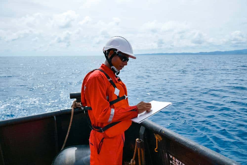 Offshore medical professional conducting health assessment at sea.