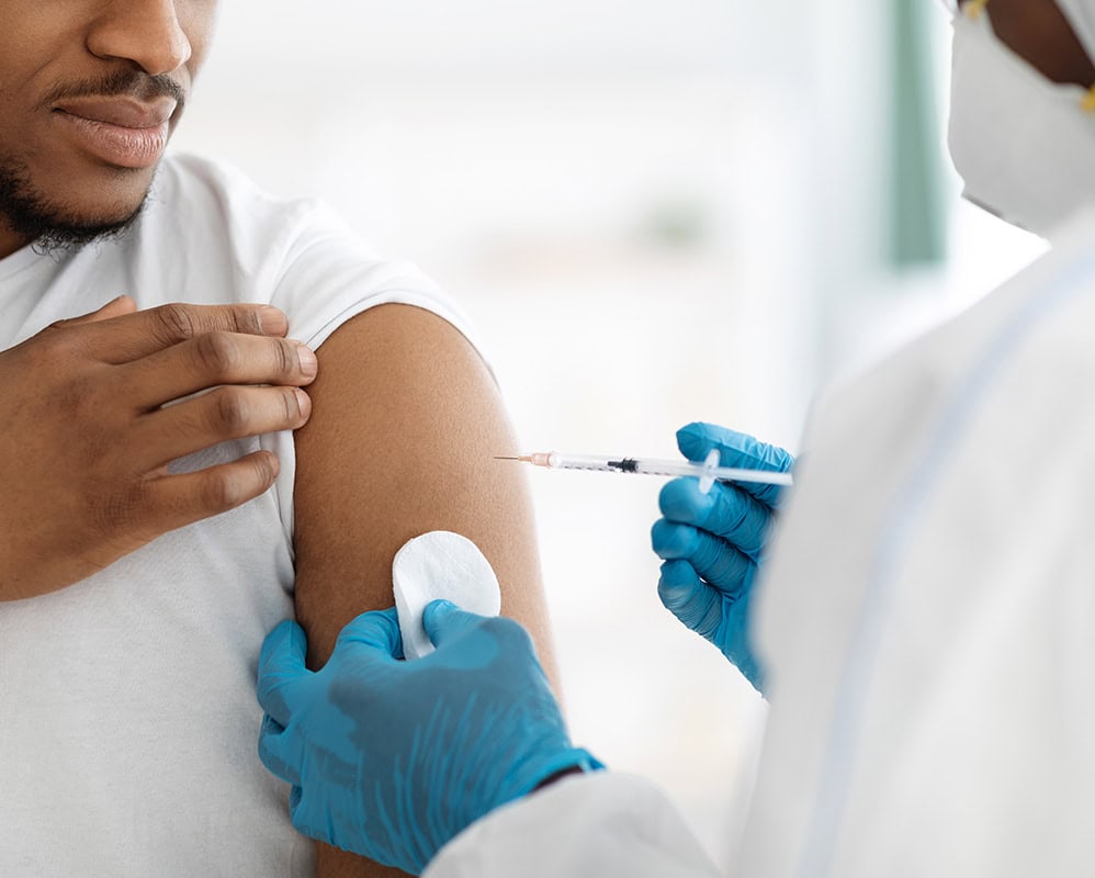 Person Receiving a Vaccination Shot in the Upper Arm.