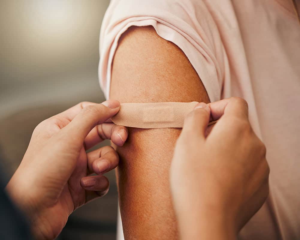 Person receiving a vaccination shot in the arm for health protection.