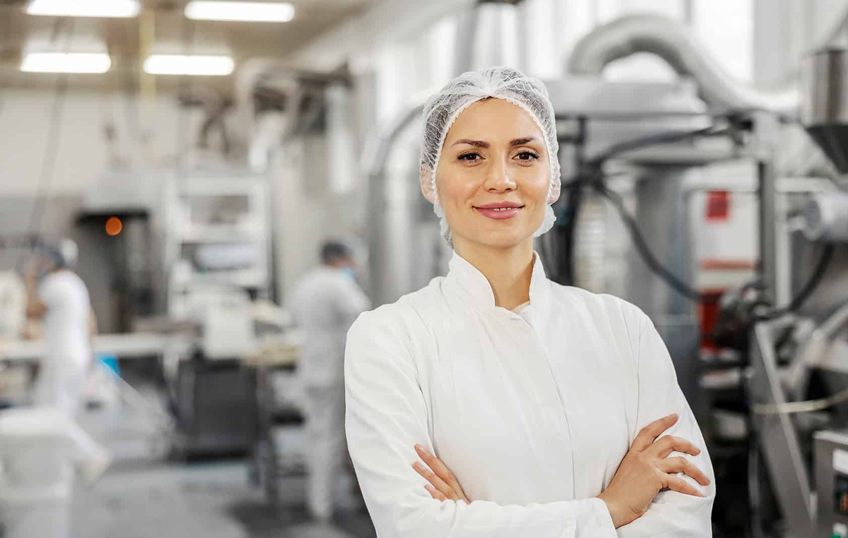 Food industry worker in a manufacturing facility promoting occupational health.