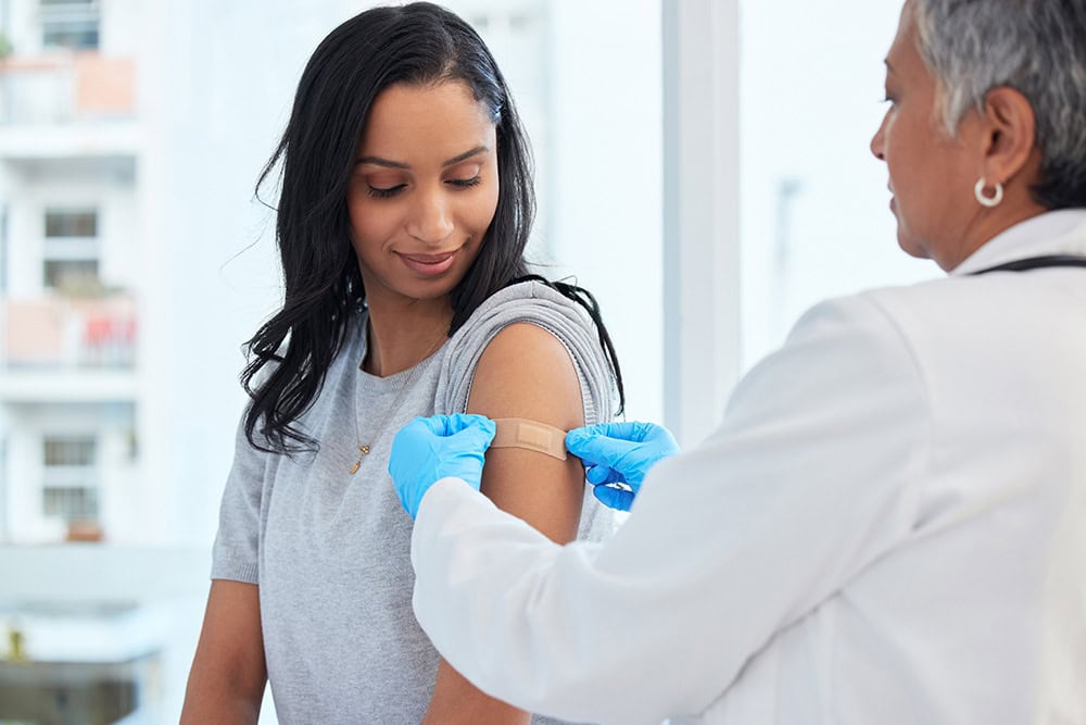 Student receiving vaccination in a healthcare setting.