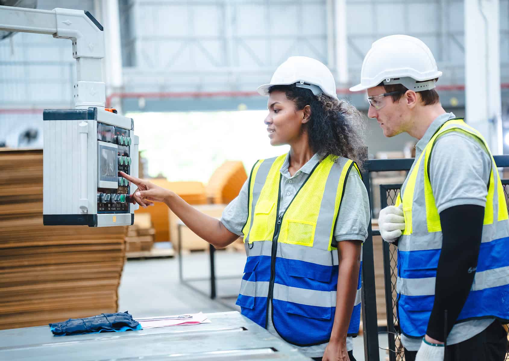 Recycling workers operating safety equipment in industrial facility.
