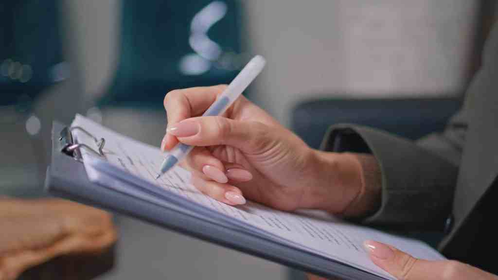 Person filling out health screening form for pre-employment checks.