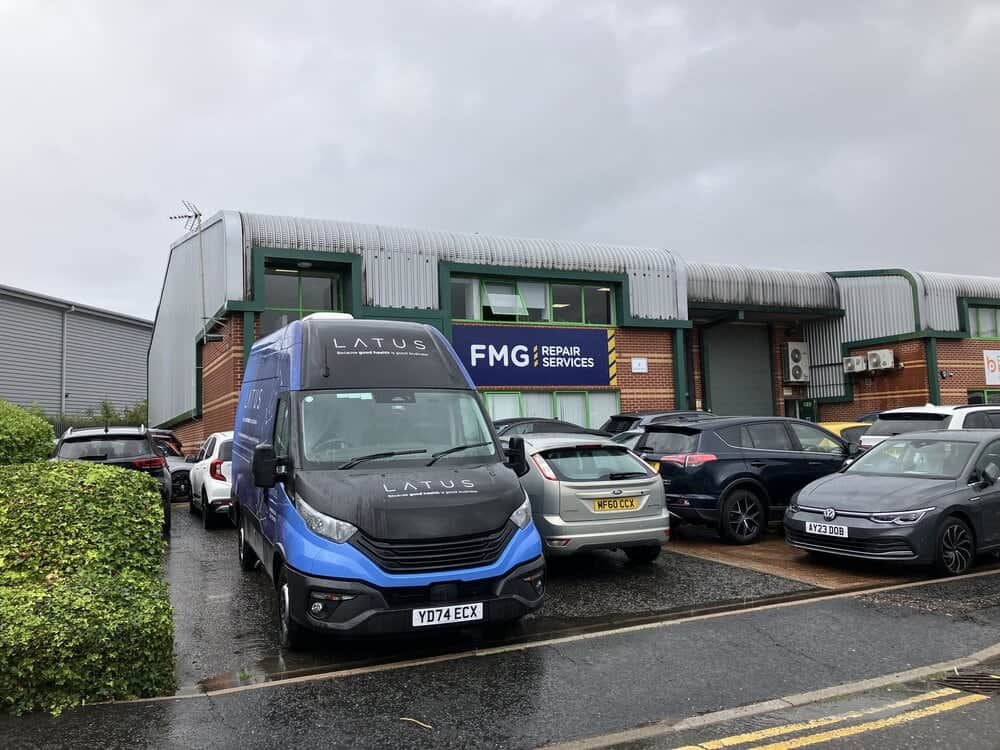 LATUS Group repair van parked outside workshop in grey weather.