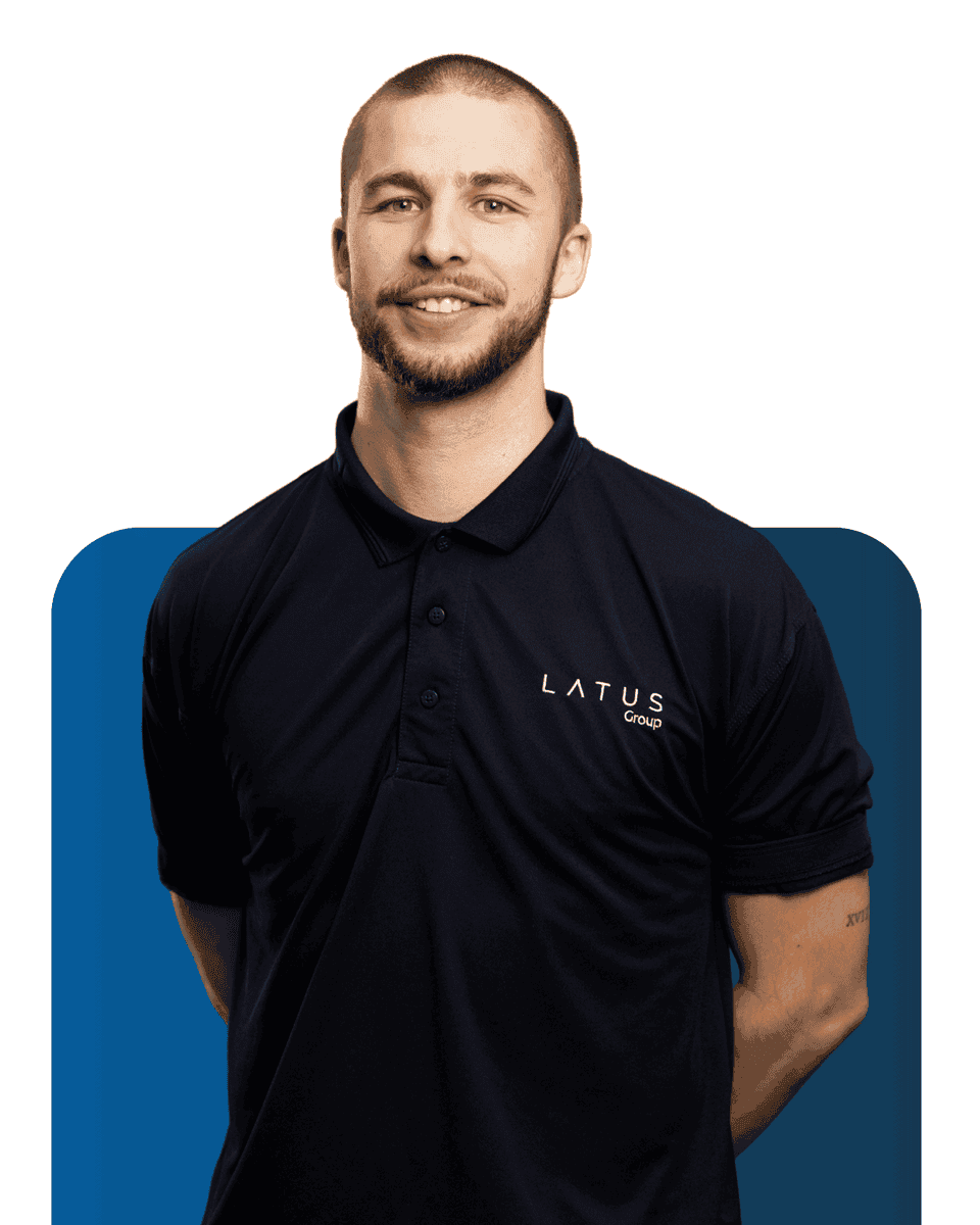 Professional team member in LATUS Group uniform smiling confidently.