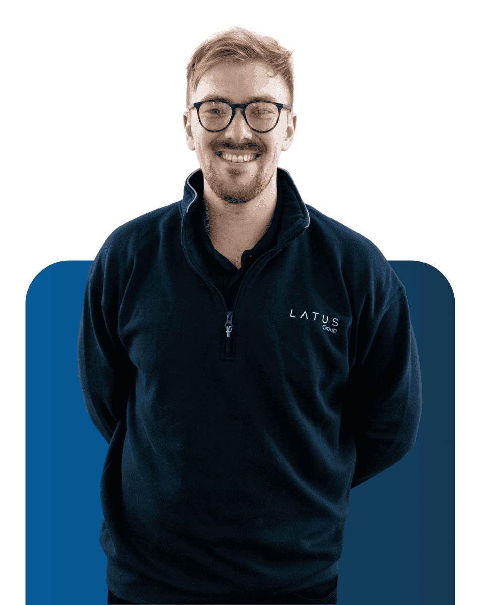 Team member smiling in LATUS Group branded jacket, showcasing professional team spirit.