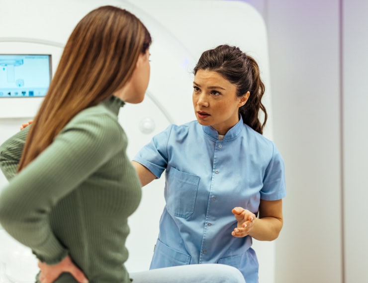 Healthcare professional discussing patient care in a clinical setting.