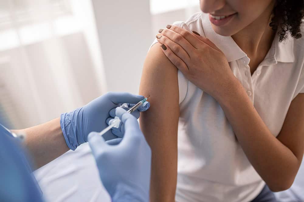 Vaccination being administered to a student for health and safety.