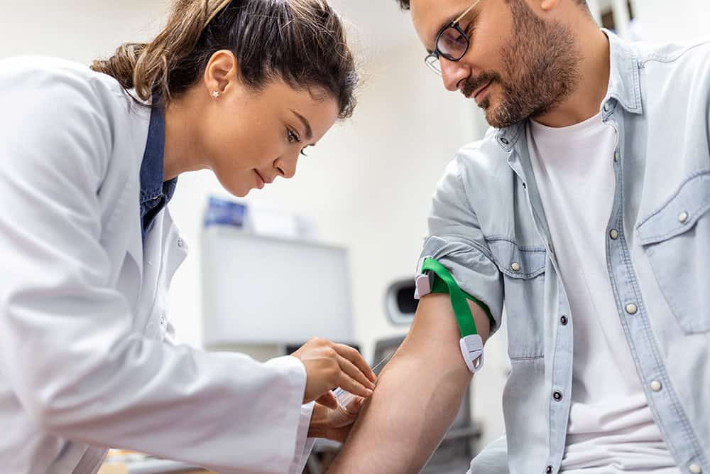 Medical professional conducting blood lead test for occupational health screening.