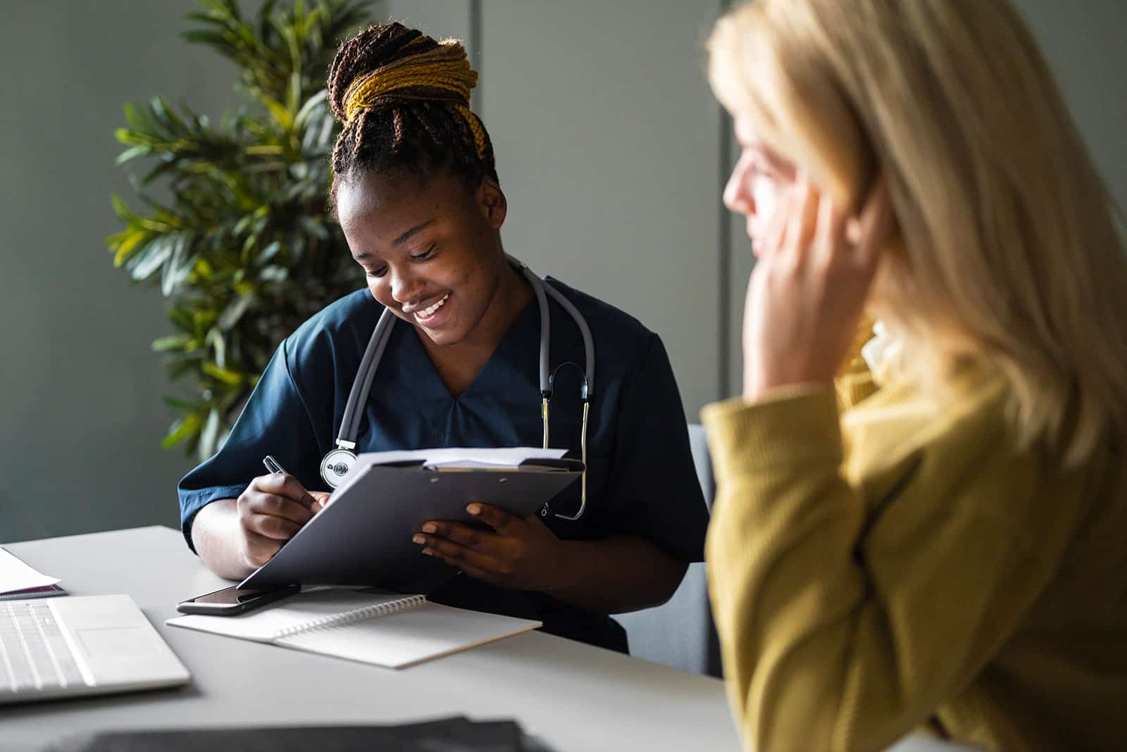 Healthcare professional consulting with patient in a clinic setting.
