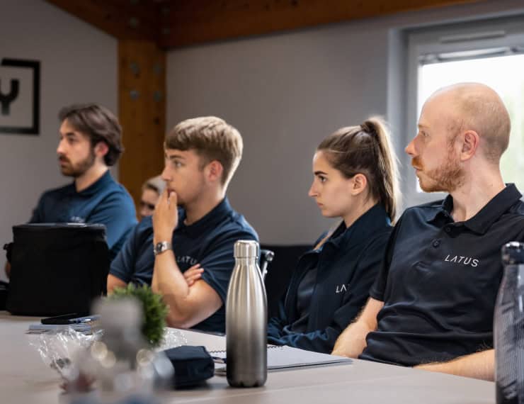 LATUS Group team attending a professional meeting in a modern office setting.