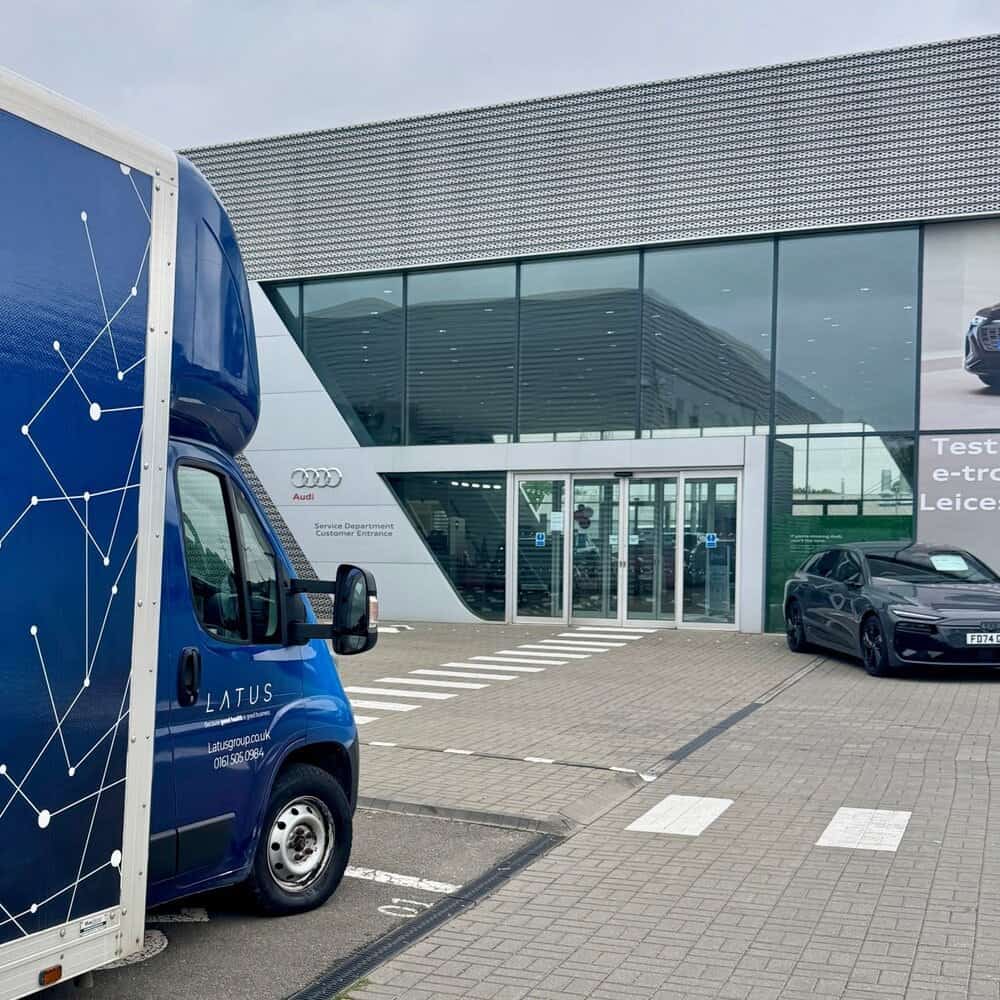 LATUS Group delivery van outside modern showroom building in UK.