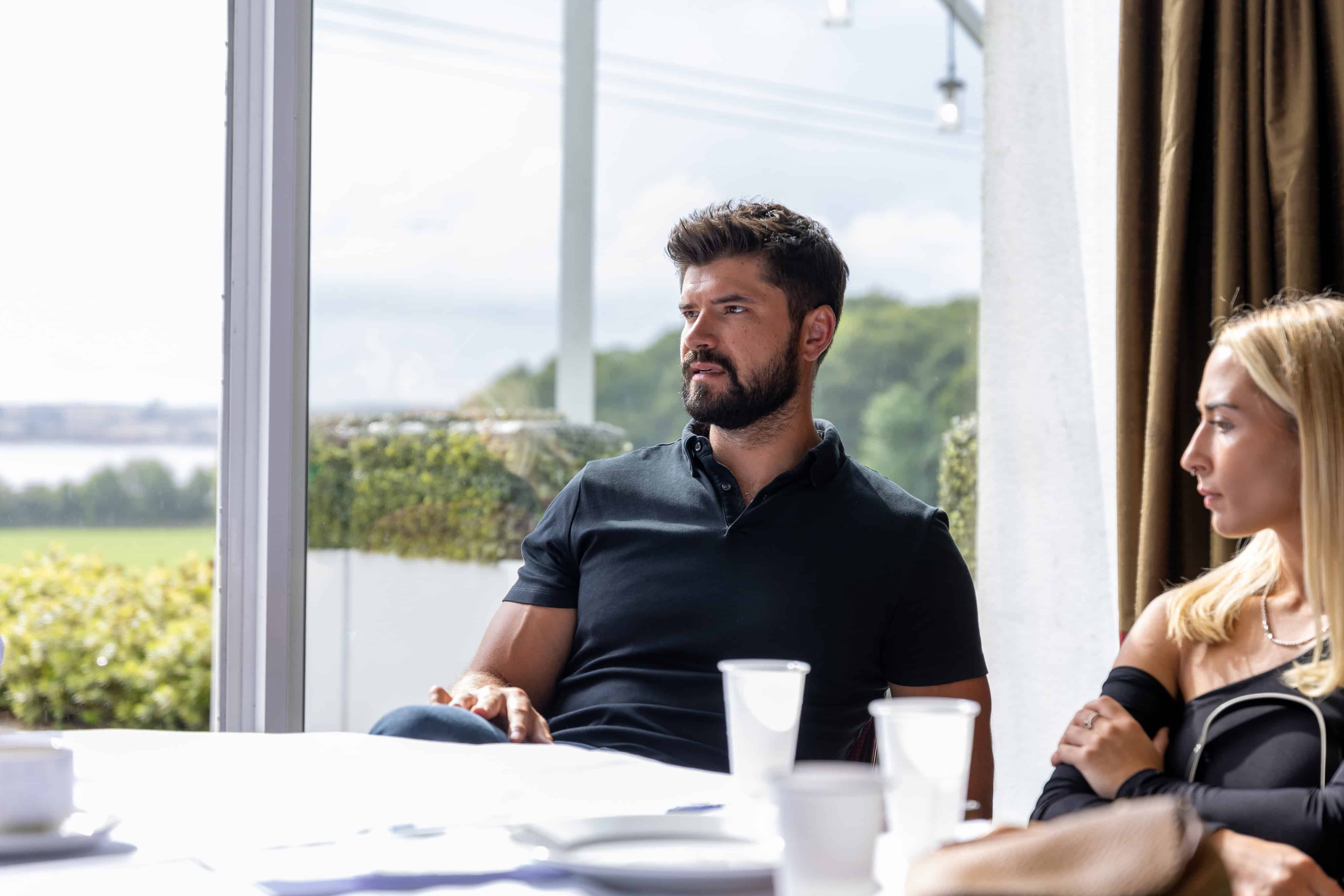 Jack Latus in a business meeting, discussing strategies with colleagues in a bright office.