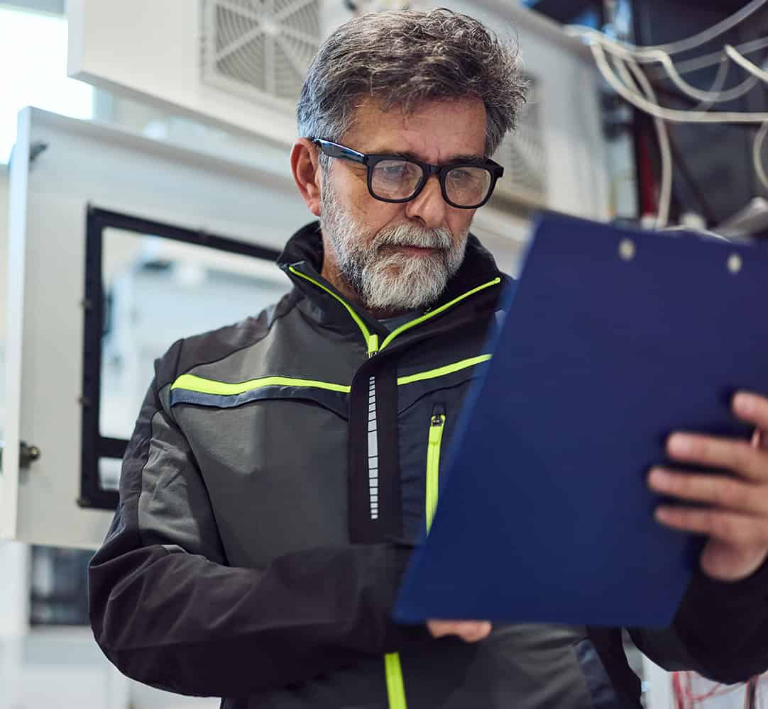 Occupational hygiene professional reviewing safety data in industrial setting.