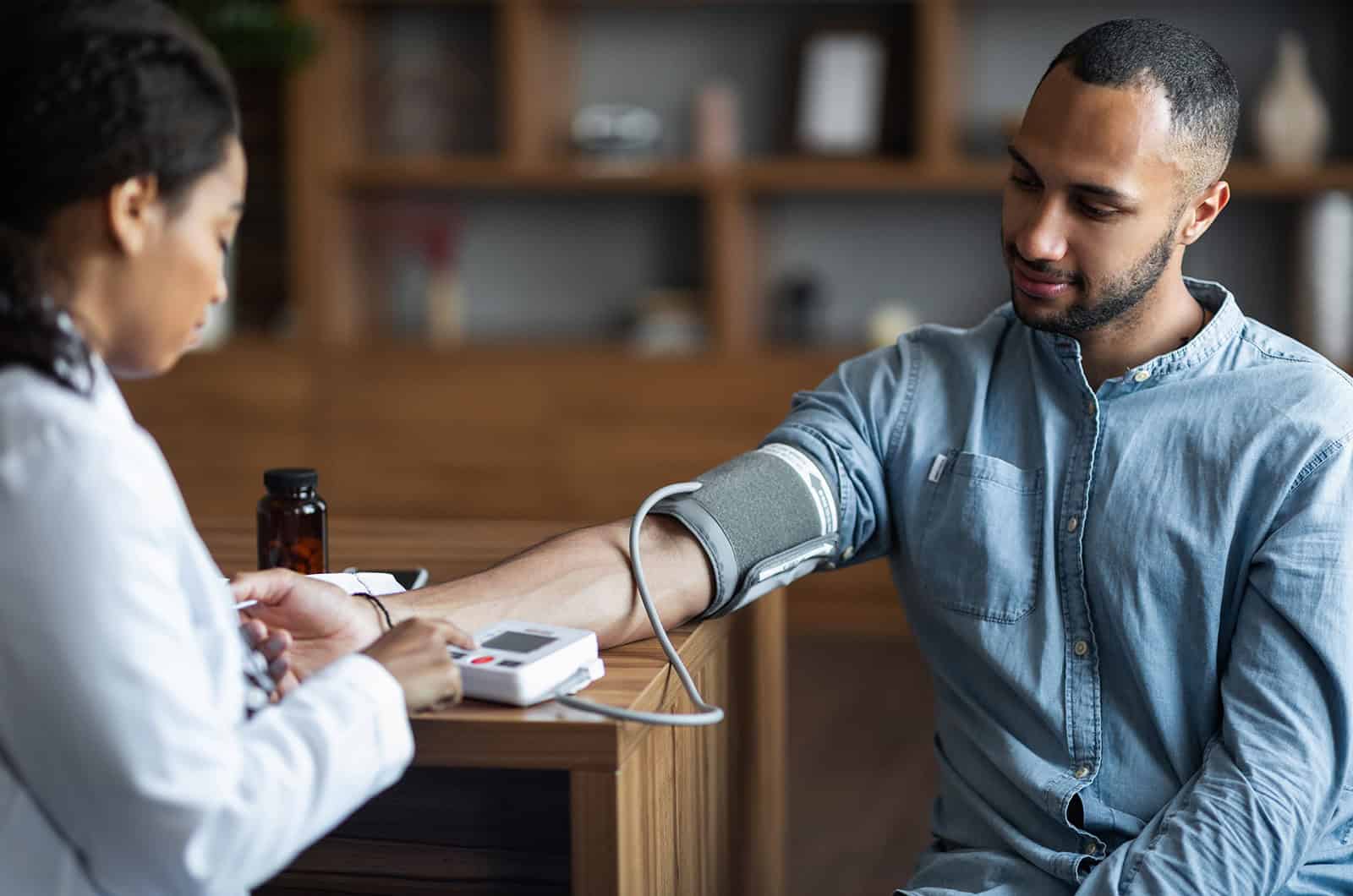 Medical professional taking blood pressure for new medical staff member.