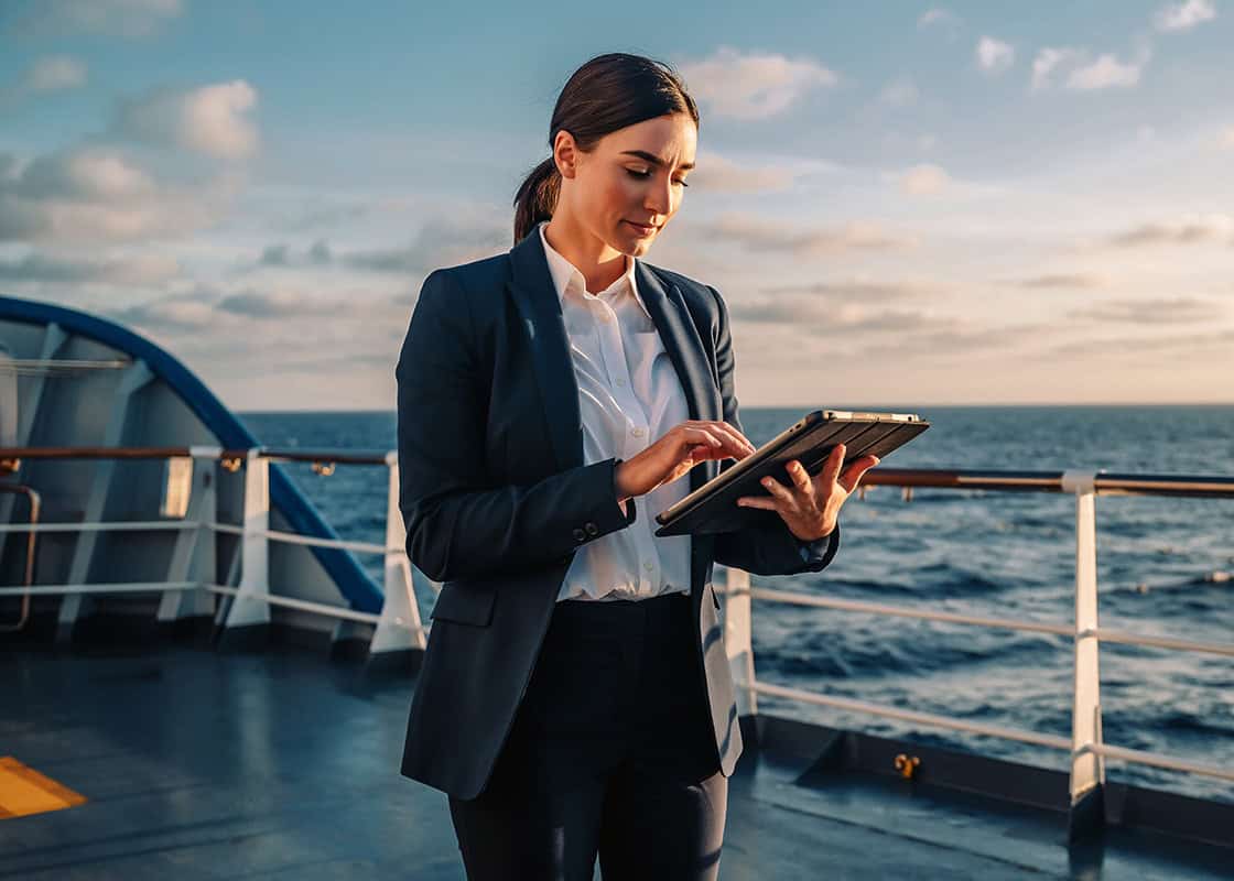 Businesswoman checking travel medical documents on a cruise deck.