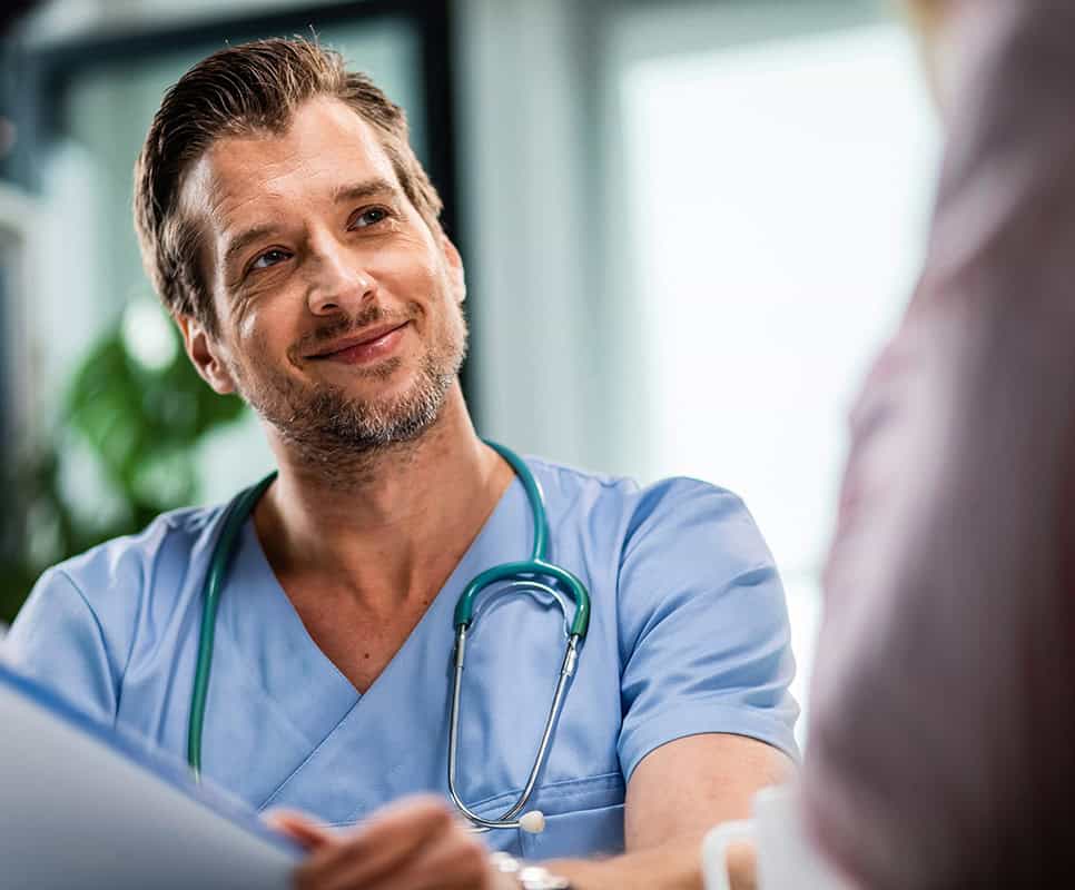 Healthcare professional discussing escalation process with patient in medical setting.