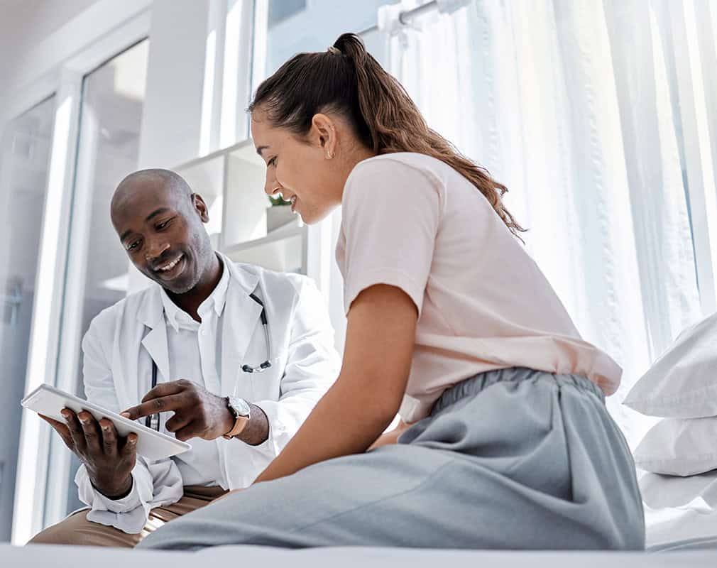 Patient consultation with healthcare professional in a clinical setting.