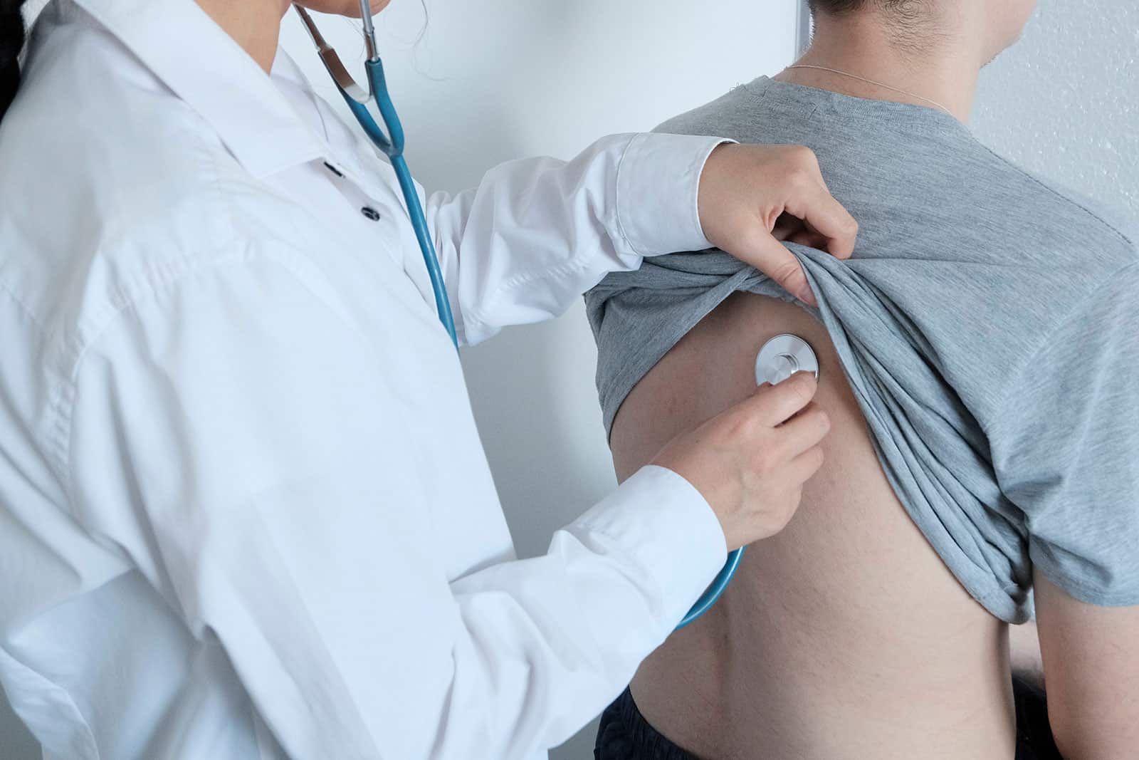 Medical professional conducting asbestos-related health check.