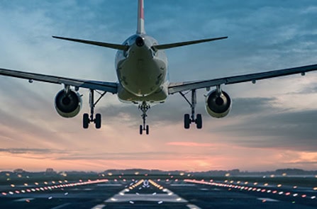 Aviation aircraft approaching runway during sunset, ready for takeoff.