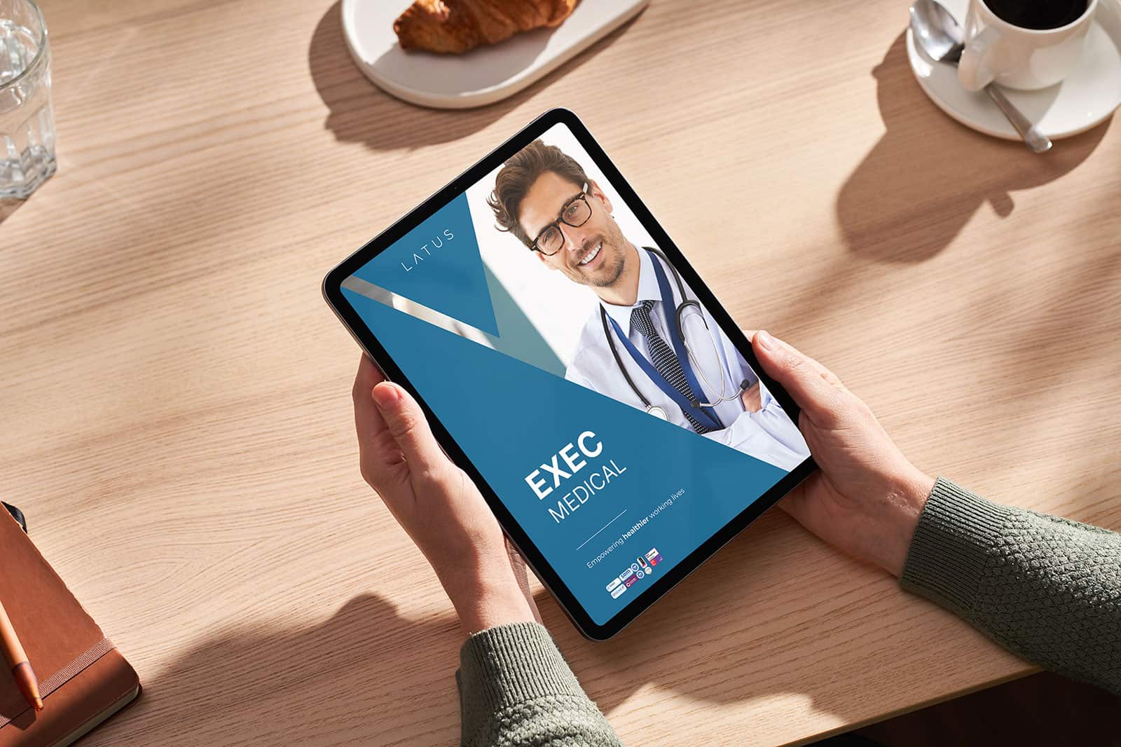 Medical professional on tablet for executive medical services at LATUS Group.