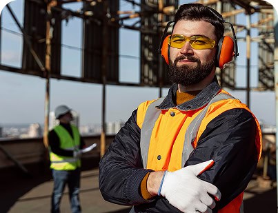 Construction worker with safety gear on a building site, representing remote health surveillance.