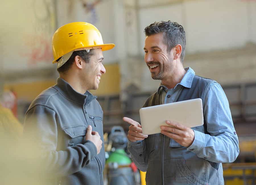 Workplace health and safety discussion between colleagues at LATUS Group.