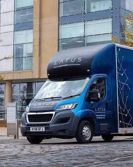 Delivery van with LATUS Group branding in an urban setting.