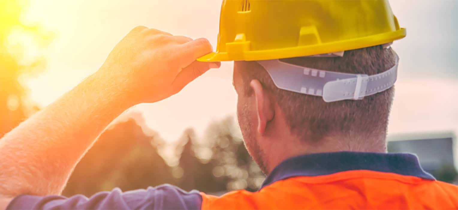 Construction worker with safety helmet, focusing on health and safety at work.
