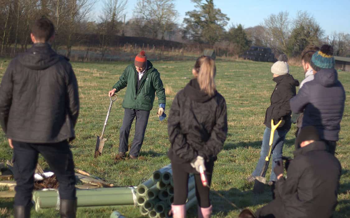 Group of people participating in environmental social and governance community cleanup.