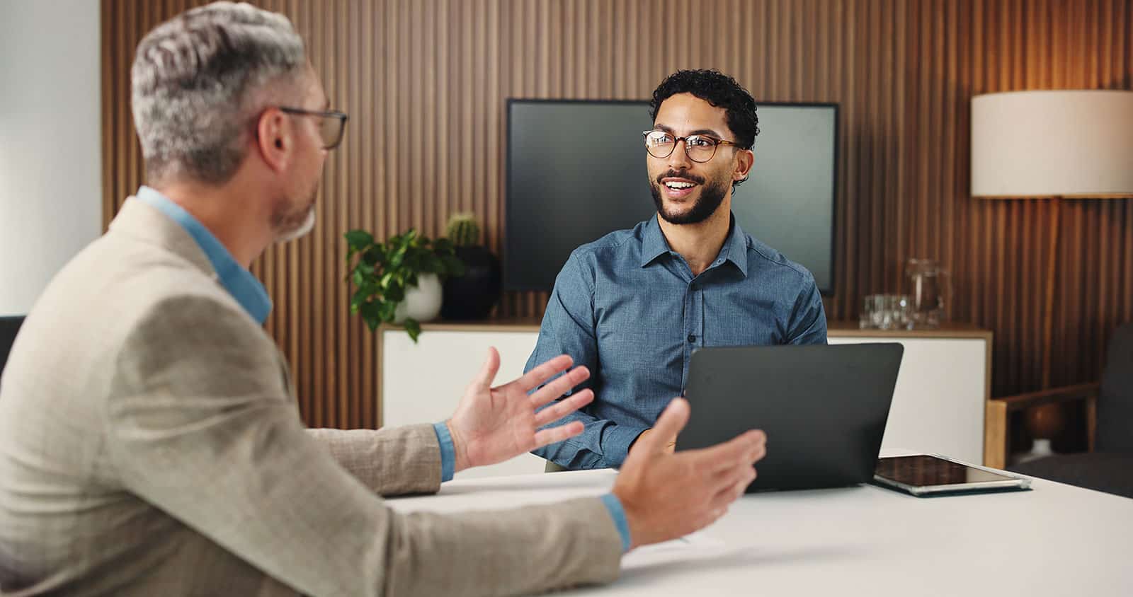 Occupational health consultation between a manager and employee in an office.
